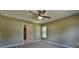 Well-lit bedroom with ceiling fan and access to bathroom at 5485 Nw 57Th Ave, Ocala, FL 34482