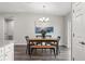 Bright dining room features a rustic wood table with bench seating and a modern chandelier at 67 Malauka Pass, Ocklawaha, FL 32179