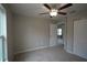 Bedroom with ceiling fan, closet and access to another room at 6725 Sw 64Th Ave, Ocala, FL 34476