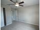 Bedroom with ceiling fan, carpet, and an ensuite bathroom at 6725 Sw 64Th Ave, Ocala, FL 34476