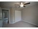 Bedroom with ceiling fan, double door closet, and access to another room at 6725 Sw 64Th Ave, Ocala, FL 34476