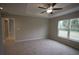 Spacious bedroom with window, ceiling fan, and access to the bathroom at 6725 Sw 64Th Ave, Ocala, FL 34476