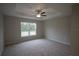 Spacious bedroom with ceiling fan and large window at 6725 Sw 64Th Ave, Ocala, FL 34476