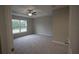 Large bedroom with ceiling fan and window at 6725 Sw 64Th Ave, Ocala, FL 34476