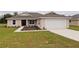 One-story house with a two-car garage and landscaped front yard at 6725 Sw 64Th Ave, Ocala, FL 34476