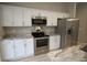 White cabinets, stainless steel appliances and granite countertops in kitchen at 6725 Sw 64Th Ave, Ocala, FL 34476