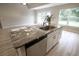 Kitchen island with granite countertop and stainless steel dishwasher at 6725 Sw 64Th Ave, Ocala, FL 34476