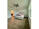 Bright main bedroom with wood-look floors and ensuite bathroom access at 7208 Sw 61St Sw Pl, Ocala, FL 34474