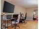 Game room features a large TV, gaming setup, and hardwood floors at 726 Marion Oaks Ln, Ocala, FL 34473