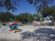 playground with swings, climbing structures, and sand at 726 Marion Oaks Ln, Ocala, FL 34473