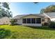 Exterior view of the home with green grass, a patio, and a screened in porch at 8569 Sw 92Nd Ln # F, Ocala, FL 34481