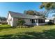 Exterior view of the home with green grass, a patio, and a screened in porch at 8569 Sw 92Nd Ln # F, Ocala, FL 34481