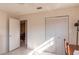 Bedroom with tile floors, bi-fold closet doors, and an open doorway to another room at 8569 Sw 92Nd Ln # F, Ocala, FL 34481