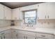 Bright kitchen featuring white cabinetry, countertops, a sink under the window, and tile backsplash at 8569 Sw 92Nd Ln # F, Ocala, FL 34481