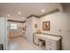 Bright kitchen featuring white cabinetry, tiled floors, and a built-in desk area at 8569 Sw 92Nd Ln # F, Ocala, FL 34481