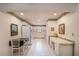 Bright kitchen featuring white cabinetry, tiled floors, and a breakfast table at 8569 Sw 92Nd Ln # F, Ocala, FL 34481