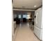 View through kitchen to living room, showing white appliances and cabinets at 8569 Sw 92Nd Ln # F, Ocala, FL 34481