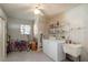 Bright laundry room featuring washer, dryer, storage shelves, utility sink, and natural light at 8569 Sw 92Nd Ln # F, Ocala, FL 34481