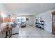 Living room featuring tile floors, comfortable seating, and natural light from the front door at 8569 Sw 92Nd Ln # F, Ocala, FL 34481