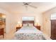 Spacious bedroom with tiled floors, ceiling fan, and bedside lamps at 8569 Sw 92Nd Ln # F, Ocala, FL 34481