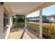 Inviting covered porch with white railing and columns, providing a relaxing outdoor space with neighborhood views at 8569 Sw 92Nd Ln # F, Ocala, FL 34481