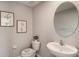 Simple bathroom with white sink, oval mirror, and gray walls at 8693 Sw 44Th Ter, Ocala, FL 34476