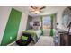 Bright bedroom with green and gray walls, a full bed, and a dresser at 8693 Sw 44Th Ter, Ocala, FL 34476