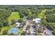 Aerial view showing community tennis courts, pool, and clubhouse at 9185 Sw 197Th Cir, Dunnellon, FL 34432