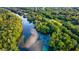 Aerial view of a lush, green landscape with a crystal-clear river at 9185 Sw 197Th Cir, Dunnellon, FL 34432