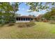 House has a large backyard with lush landscaping at 9185 Sw 197Th Cir, Dunnellon, FL 34432