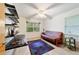 Bedroom with a futon, built-in shelving, and a large window at 9185 Sw 197Th Cir, Dunnellon, FL 34432