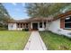 Front entrance of a house with walkway and landscaping at 9185 Sw 197Th Cir, Dunnellon, FL 34432