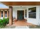 Covered porch with a swing, terracotta tile floor, and teal door at 9185 Sw 197Th Cir, Dunnellon, FL 34432