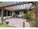 Relaxing brick patio area with a pergola and potted plants at 9185 Sw 197Th Cir, Dunnellon, FL 34432