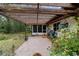 Brick patio with wooden pergola, providing shade and outdoor space at 9185 Sw 197Th Cir, Dunnellon, FL 34432