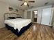 Main bedroom with hardwood floors, ceiling fan and en-suite bathroom at 9581 Se 168Th Elderberry Pl, The Villages, FL 32162