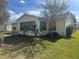 House exterior with a sunroom and landscaping at 9581 Se 168Th Elderberry Pl, The Villages, FL 32162