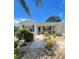 Inviting home entrance with lush landscaping and a well-maintained walkway leading to the front door at 9581 Se 168Th Elderberry Pl, The Villages, FL 32162