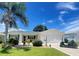 Charming single-story home with a well-manicured lawn, lush landscaping, and a convenient attached two-car garage at 9581 Se 168Th Elderberry Pl, The Villages, FL 32162
