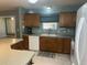 Modern kitchen with wood cabinets, tile flooring, and stainless steel appliances at 9581 Se 168Th Elderberry Pl, The Villages, FL 32162