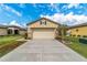 Single-story house with attached garage and landscaped yard at 9661 Sw 63Rd Loop, Ocala, FL 34481