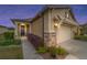 Tan house with a brown door and attached garage at dusk at 9661 Sw 63Rd Loop, Ocala, FL 34481