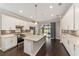 Modern kitchen with white cabinets, stainless steel appliances and an island at 9661 Sw 63Rd Loop, Ocala, FL 34481