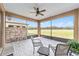 Enjoy serene views from this screened porch, featuring a tiled floor and ceiling fan at 9661 Sw 63Rd Loop, Ocala, FL 34481