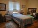 Bedroom with a twin bed, nightstand, and wood flooring at 10729 Sw 62Nd Ave, Ocala, FL 34476