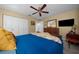 Inviting bedroom with ceiling fan, mounted tv, and a warm decor at 10820 Sw 80Th Ct, Ocala, FL 34481