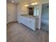Double vanity bathroom with granite countertops and large mirror at 12295 Sw 90Th Pl, Dunnellon, FL 34432