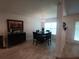 Dining area with tile floors, modern chandelier, and a bar with wine storage at 12295 Sw 90Th Pl, Dunnellon, FL 34432