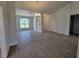 Open living area with a decorative chandelier, arched window, and wood-look tile flooring at 12295 Sw 90Th Pl, Dunnellon, FL 34432