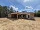 Back exterior showing the covered patio and block construction of the new home ready for finishing at 12295 Sw 90Th Pl, Dunnellon, FL 34432